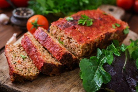 Creole Meat Loaf on a wooden cutting board.