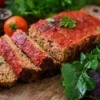 Creole Meat Loaf on a wooden cutting board.