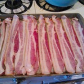 A pan of bacon on a cookie sheet, ready for the oven.