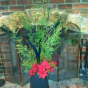 DIY Holiday Centerpieces - cedar and poinsettia decoration on hearth