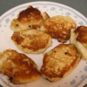 Gluten Free Potato Cakes Browned potato cakes on plate.