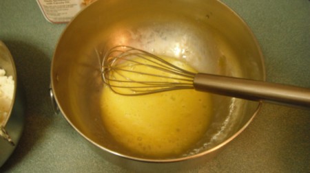 Gluten Free Potato Cakes Whisking egg in bowl.