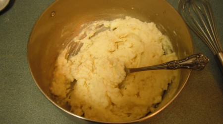 Gluten Free Potato Cakes mixing whisked egg mixed into potatoes.