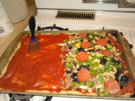 Homemade Pizza with added toppings on half