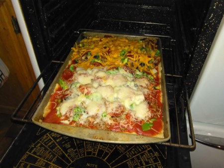 Homemade Pizza on cookie sheet in oven