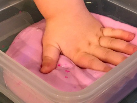 Homemade Flubber - toddler's hand mashing flubber