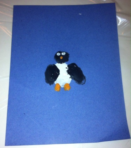 Fingerprint Penguin - use paintbrush with orange paint to make mouth and feet and white and black paint for the eyes