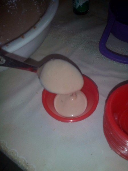 Put Cheese pouring spoonful of batter into steaming cup.