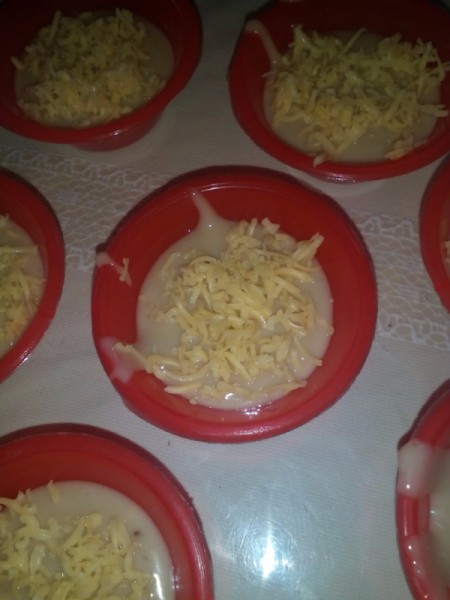 Put Cheese adding grated cheese to steaming cup