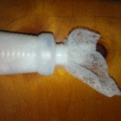 Homemade Static Guard - dryer sheet being placed in spray bottle