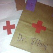 Doctor's Bag Craft - cut out red crosses for bags and glue in place