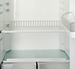 White metal shelf in a refrigerator.