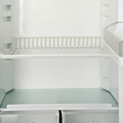 White metal shelf in a refrigerator.