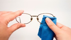Cleaning glasses with a  microfiber cloth and cleaner.