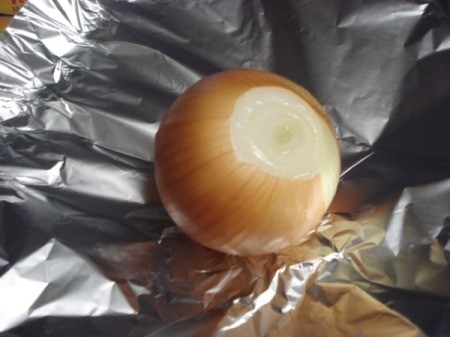 onion with top cut off on foil