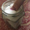 DIY Nail Polish Remover Jar - dipping thumb into jar to remove polish with polish residue on sponge