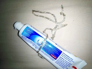 A tube of toothpaste and a silver chain.