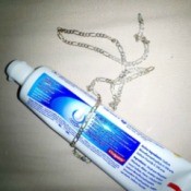 A tube of toothpaste and a silver chain.