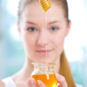 A girl with a jar of honey.