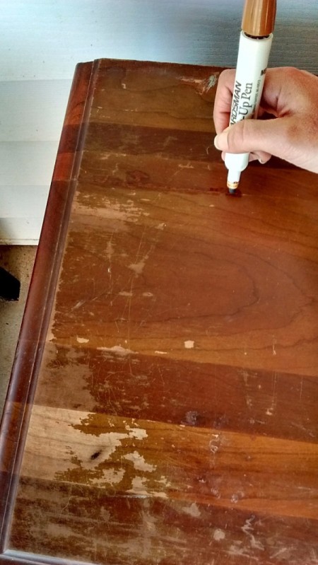 How to Fix Damaged Surfaces of Wood Furniture - covering damaged spots with marking pen