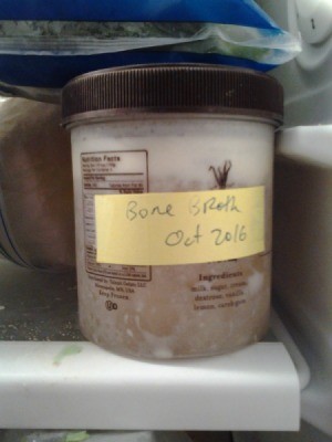 jar labeled as bone broth in the freezer