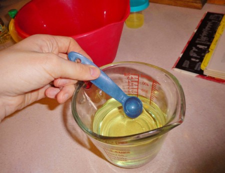 Adding oil one tsp. at a time.