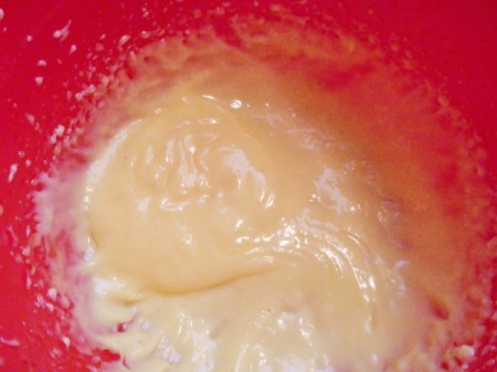 Adding oil to egg yolk.