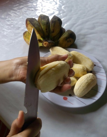 Cutting banana in fan shape.
