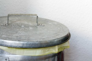 Close up of top of a galvanized steel garbage can.