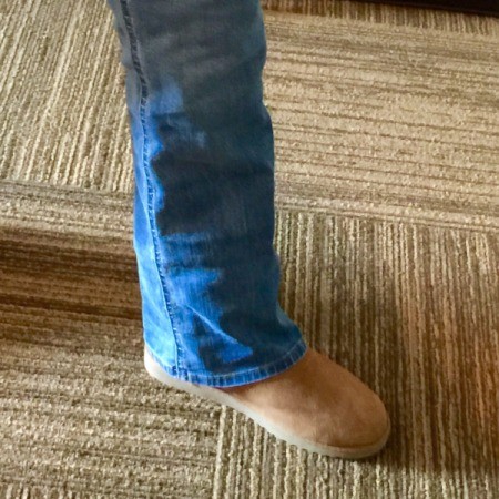 A leg wearing jeans and boots.