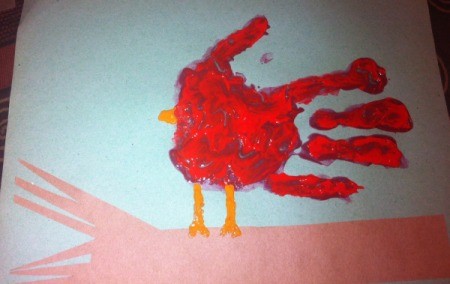 Handprint Winter Cardinals - place a red handprint an inch above the branch, thumb up, add legs and beak with orange paint