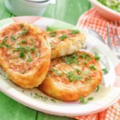 Plate of potato cakes sprinkled with parsley.