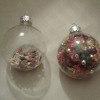 Two clear ornaments filled with beads.