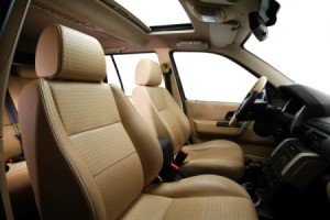 The interior of a car with brown leather seats.