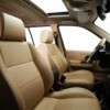 The interior of a car with brown leather seats.