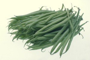 A pile of green beans on a light background.