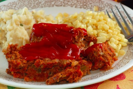 A dinner plate featuring meatloaf.
