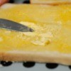 A piece of toast with melted butter.