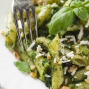 A plate of pesto penne with chicken.