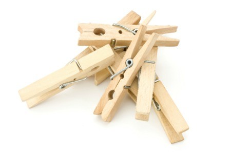 A pile of clothespins on a white background.