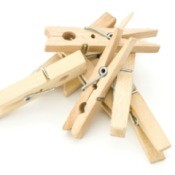 A pile of clothespins on a white background.