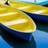 Two yellow and blue fiberglass rowboats.