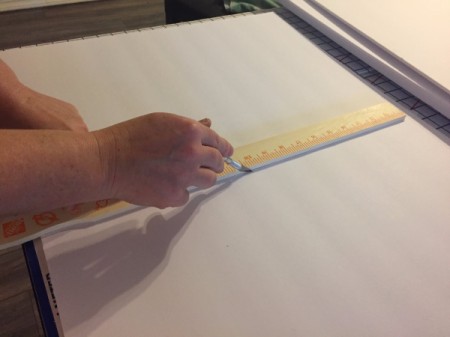 Cutting the foam core in half with an X-acto knife.