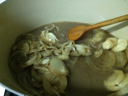 Cooked onions and gravy in pan