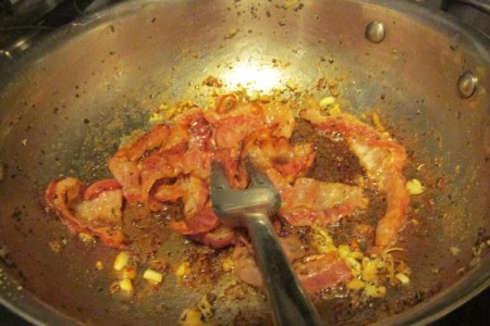 Cooking bacon and garlic in pan