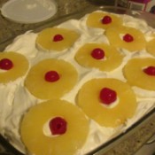 Pineapple with cherries on top of pan.