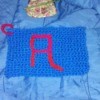 A crocheted dishrag with a letter "A".