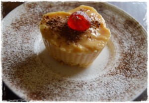 A heart shaped butterscotch pudding dessert, on a plate.