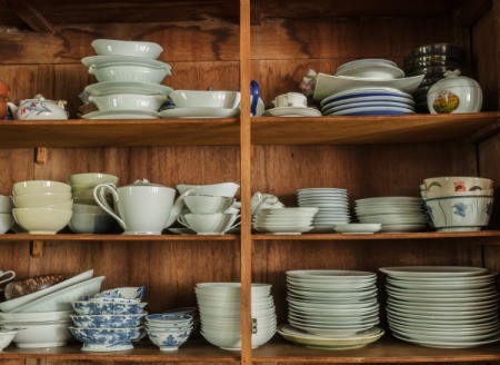 A cabinet with several types of dishes.