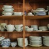 A cabinet with several types of dishes.